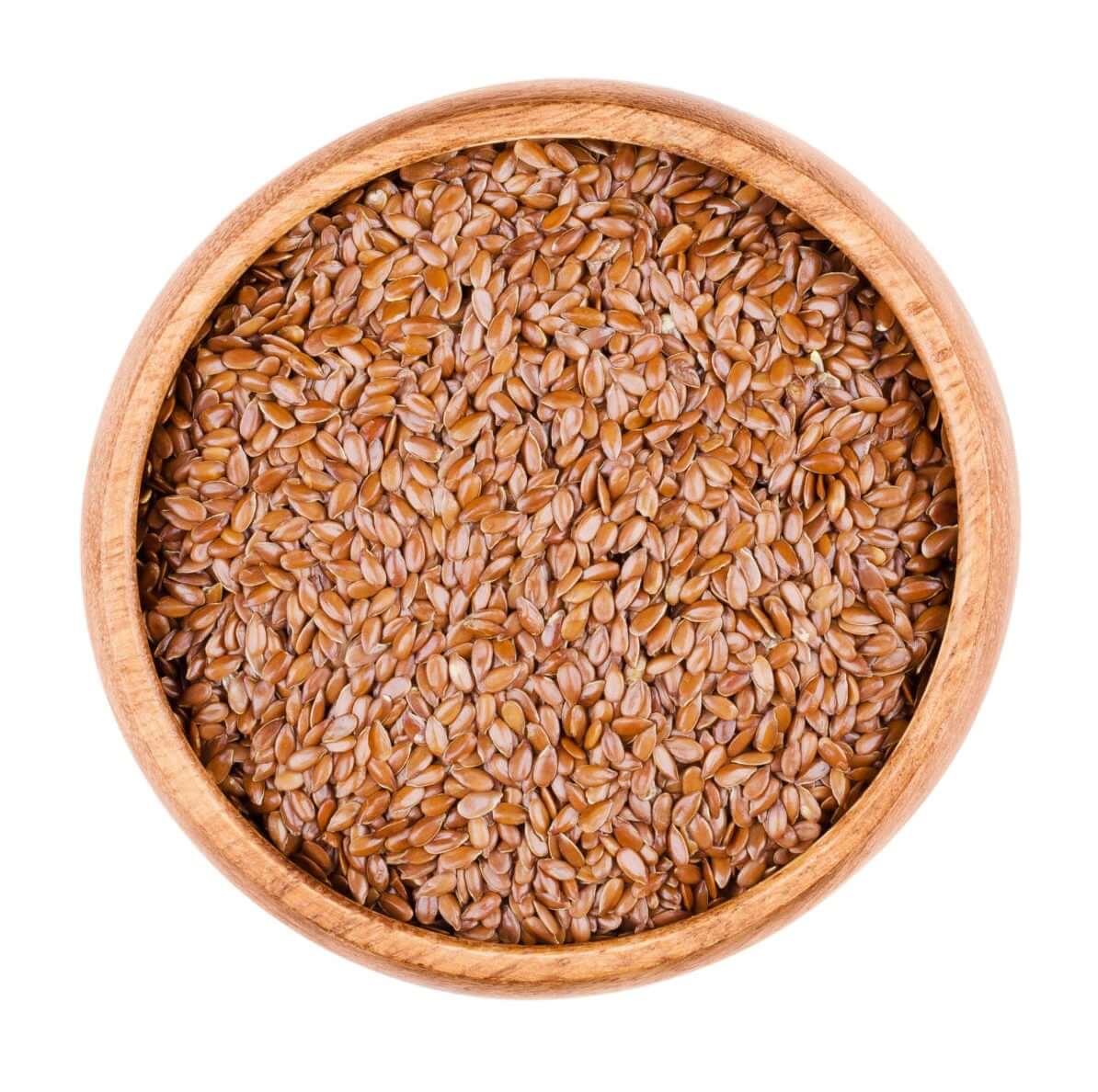 Brown flaxseeds in a wooden bowl